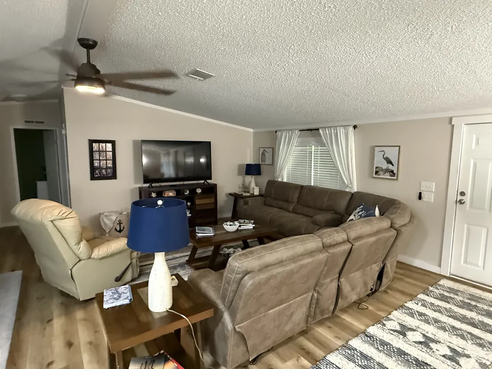 Comfortable living room at Sapelo House with recliners, sofa seating, and coastal decor.