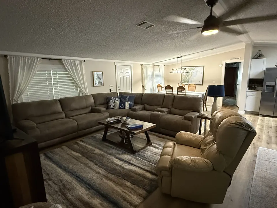 Spacious living room at Sapelo House with a large sectional sofa, coffee table, and open layout.
