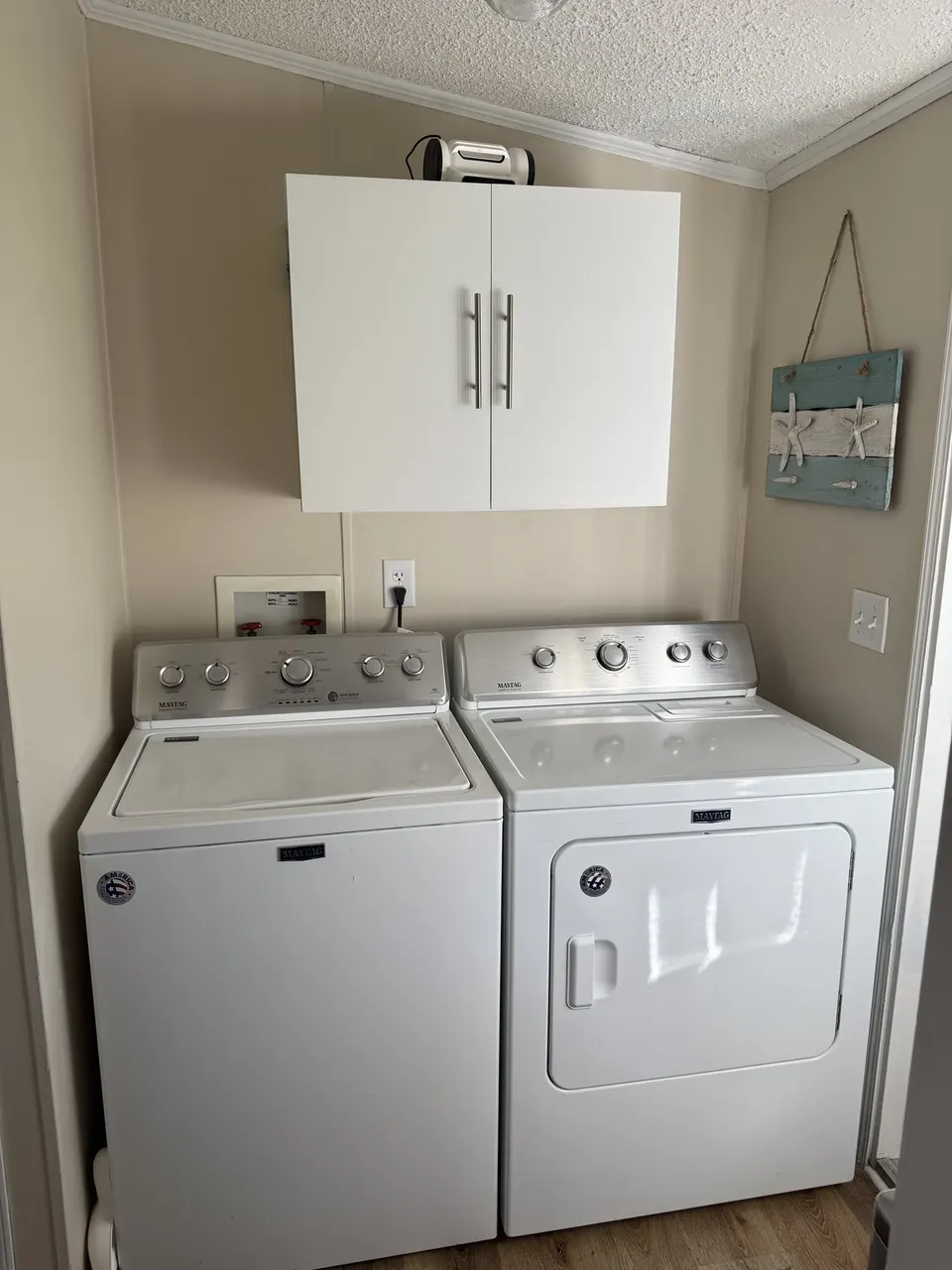 Laundry area at Sapelo House with a full-size washer and dryer for guest convenience.
